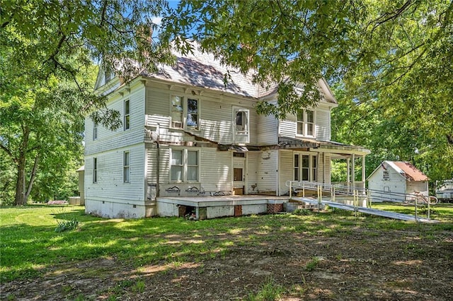 rear view of property with a lawn