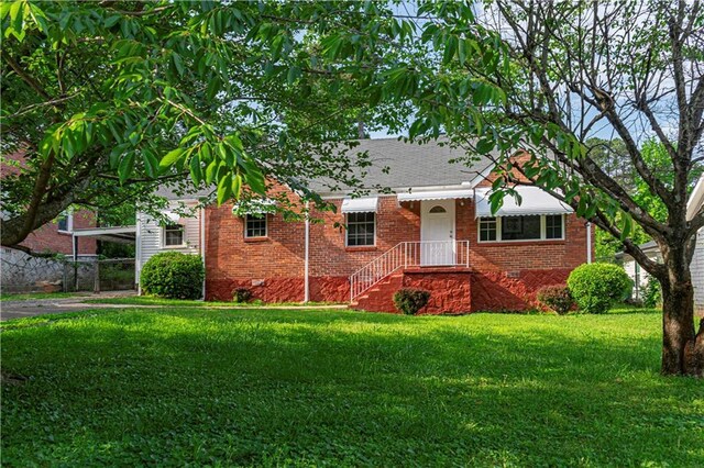 2656 Northview Ave, Decatur, GA 30032 - ranch-style home featuring brick siding, an attached carport, driveway, and a front yard
