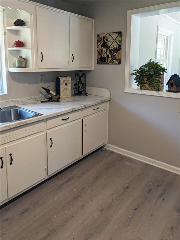 2656 Northview Ave, Decatur, GA 30032 - kitchen featuring white cabinets, a sink, light countertops, baseboards, and dark wood-type flooring