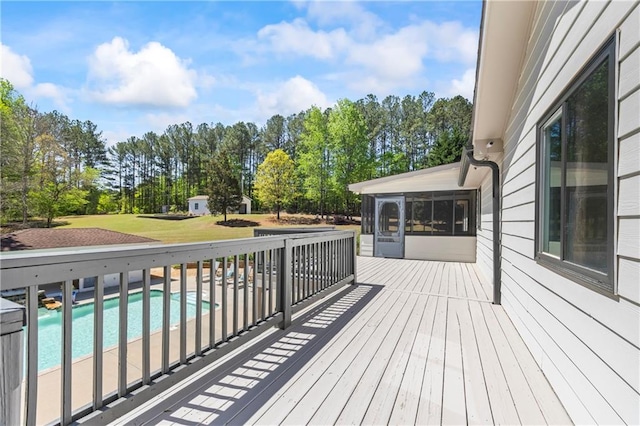 deck with an outdoor pool and a yard