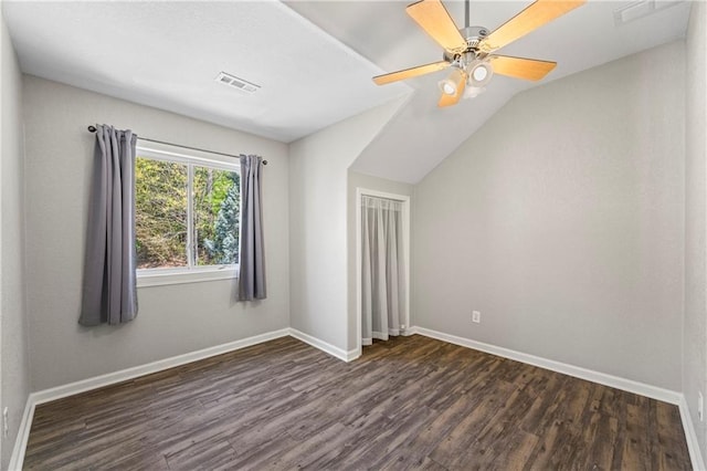 interior space with visible vents, lofted ceiling, baseboards, ceiling fan, and dark wood-style floors