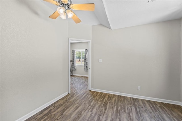 unfurnished room featuring a ceiling fan, baseboards, vaulted ceiling, and wood finished floors