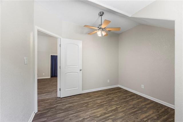 empty room featuring baseboards, ceiling fan, wood finished floors, and lofted ceiling
