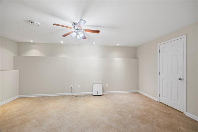 empty room with baseboards and a ceiling fan