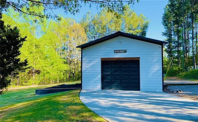 detached garage with concrete driveway