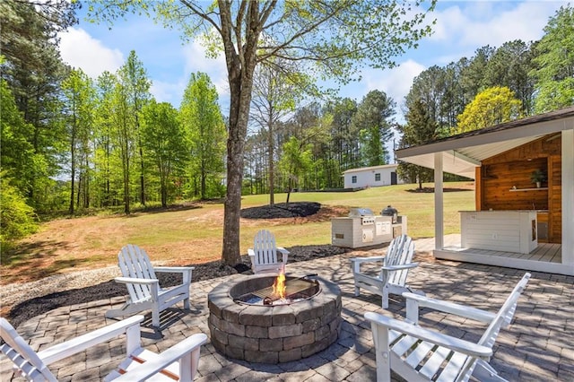 view of patio / terrace featuring an outdoor fire pit