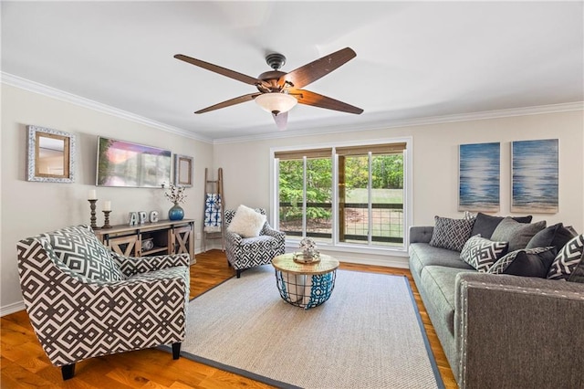 living room with crown molding, a ceiling fan, baseboards, and wood finished floors