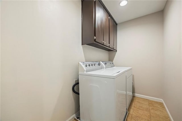 clothes washing area with cabinet space, light tile patterned flooring, separate washer and dryer, recessed lighting, and baseboards