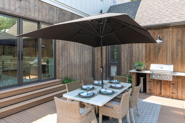 wooden deck with outdoor dining area and a grill