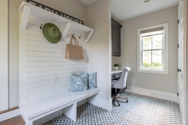 mudroom with tile patterned floors and baseboards