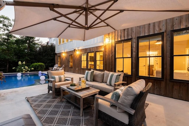 view of patio with an outdoor living space and an outdoor pool