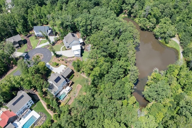 aerial view featuring a water view and a wooded view