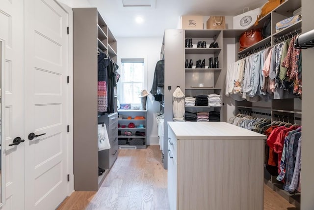 spacious closet featuring light wood-style flooring and attic access