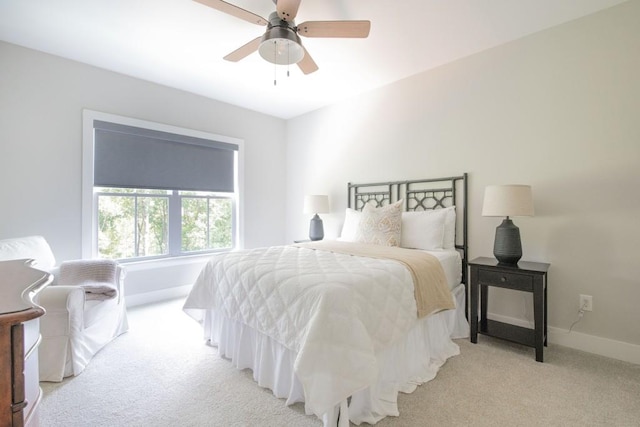 bedroom featuring baseboards, a ceiling fan, and light carpet