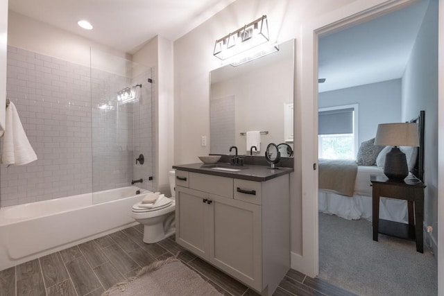 full bathroom featuring vanity, bathtub / shower combination, toilet, ensuite bath, and wood tiled floor