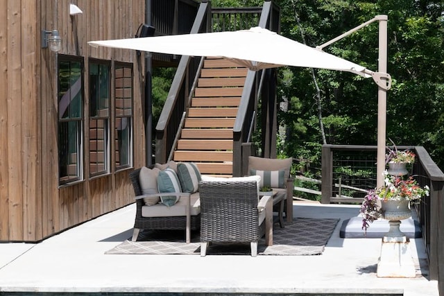 wooden deck with stairway and a patio area