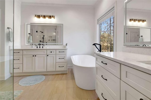 bathroom with vanity, ornamental molding, and shower with separate bathtub