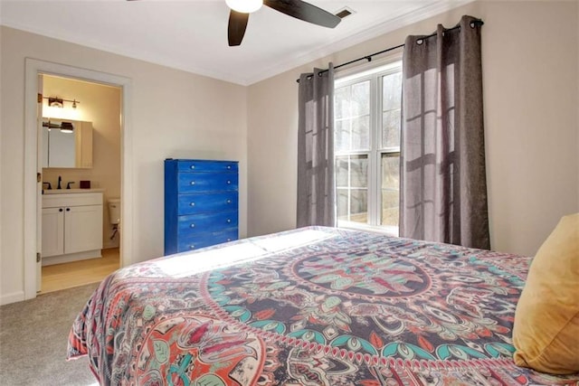 bedroom featuring crown molding, light carpet, ceiling fan, and ensuite bathroom