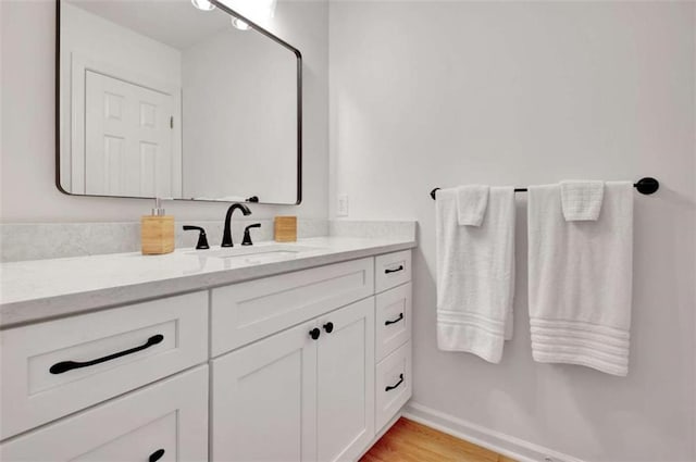 bathroom featuring vanity and wood-type flooring