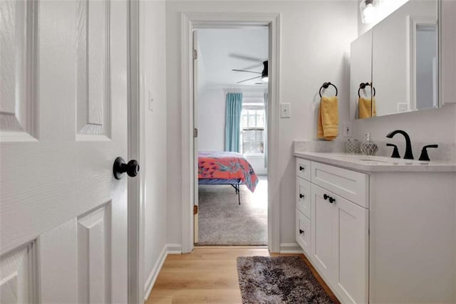 bathroom featuring ceiling fan, vanity, and hardwood / wood-style floors