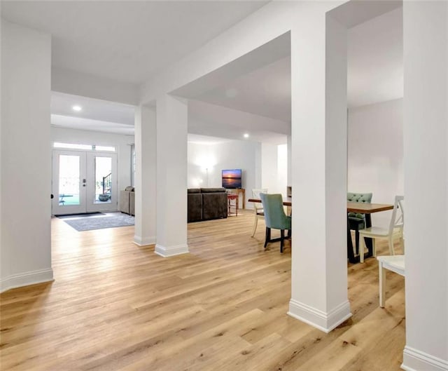 interior space featuring light wood-type flooring and french doors