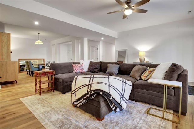 living room featuring ceiling fan and wood-type flooring