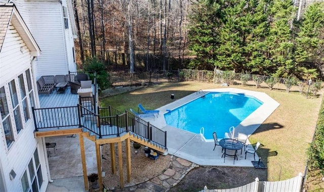 view of pool with a patio, a yard, and a deck