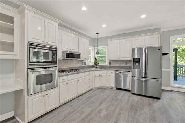 4955 Day Lily Way NW, Acworth, GA 30102 - kitchen with stainless steel appliances, light wood finished floors, decorative backsplash, pendant lighting, and white cabinetry