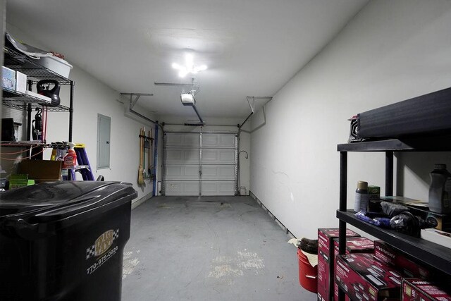garage featuring a garage door opener and electric panel