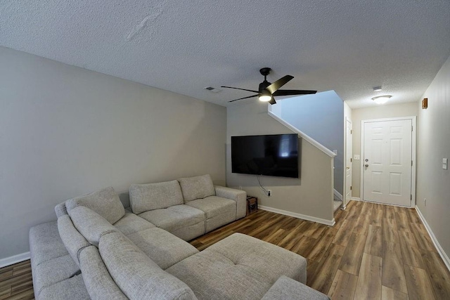 living room featuring a textured ceiling and wood finished floors