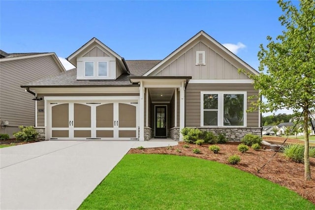 2012 Ripple Park Bnd, Canton, GA 30114 - craftsman-style house with stone siding, concrete driveway, roof with shingles, a front yard, and an attached garage