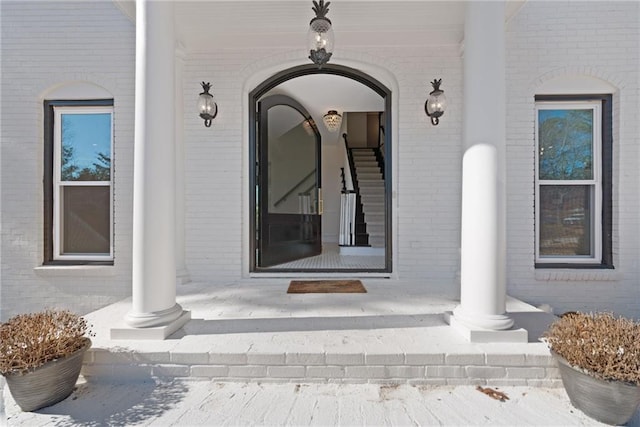 snow covered property entrance featuring covered porch