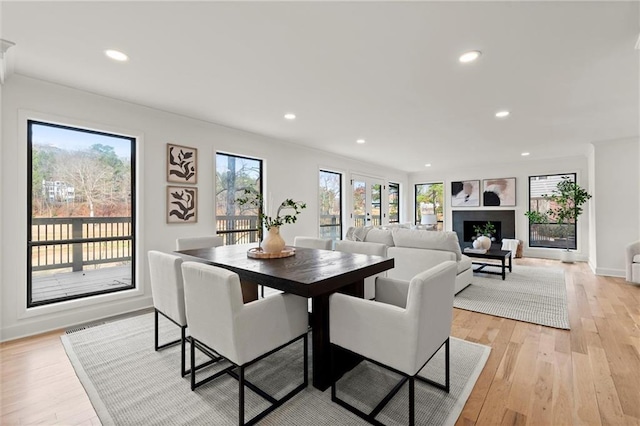 dining area featuring recessed lighting, light wood-type flooring, and baseboards