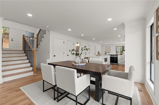 dining space featuring stairs, recessed lighting, and light wood finished floors