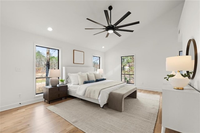 bedroom with recessed lighting, baseboards, multiple windows, and light wood-style floors