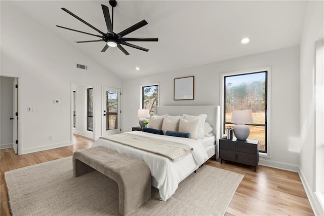 bedroom featuring light wood-type flooring, visible vents, multiple windows, and access to outside