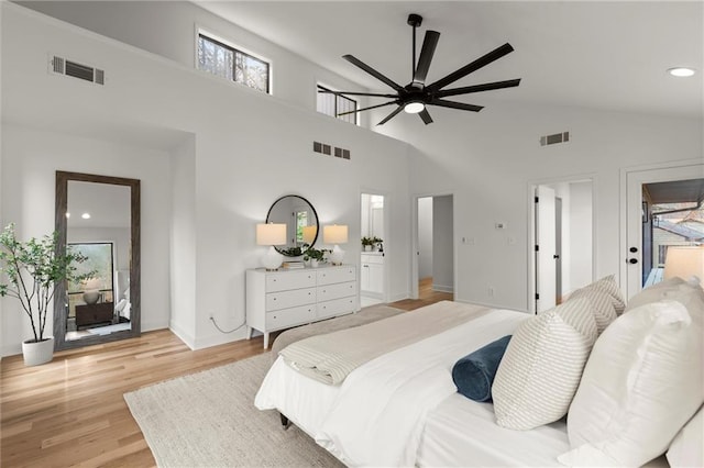 bedroom with visible vents, ensuite bath, and light wood-style flooring