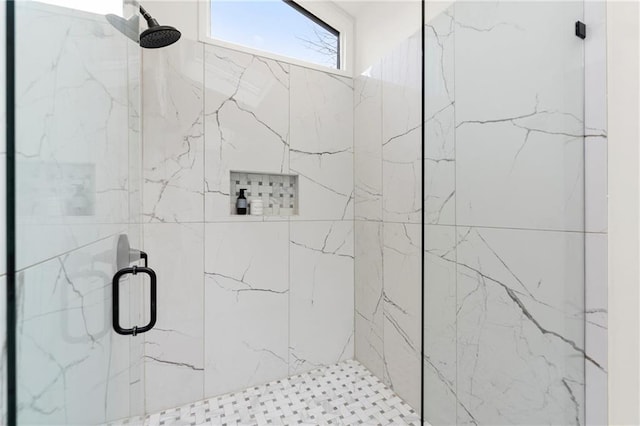 bathroom featuring a marble finish shower