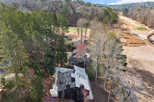 birds eye view of property featuring a wooded view