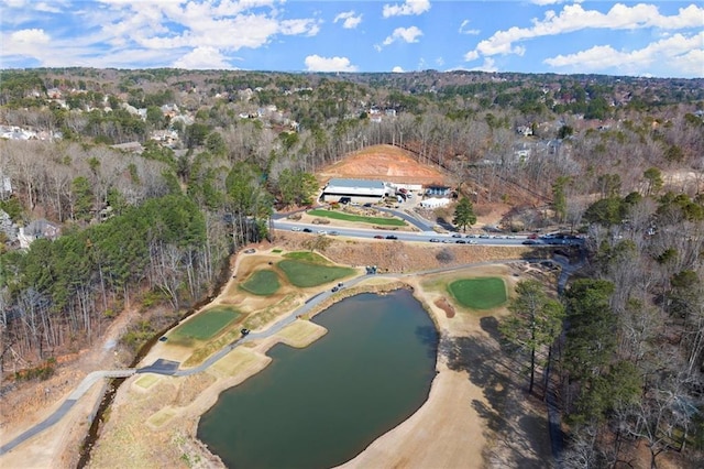 birds eye view of property featuring a forest view and a water view