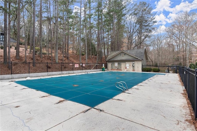 pool with a patio and fence