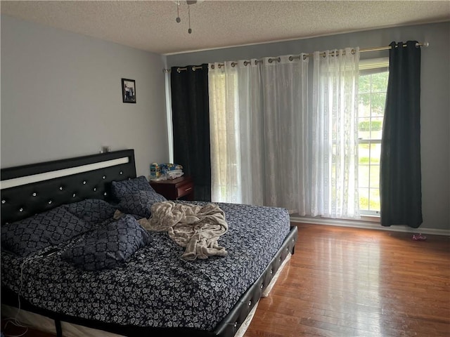 1159 Aurora Ct, Atlanta, GA 30338 - bedroom with hardwood / wood-style floors and a textured ceiling