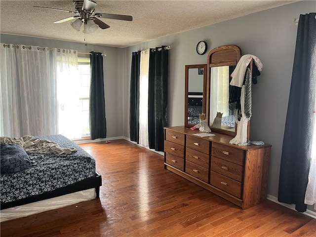 1159 Aurora Ct, Atlanta, GA 30338 - bedroom featuring wood finished floors, a textured ceiling, and ceiling fan