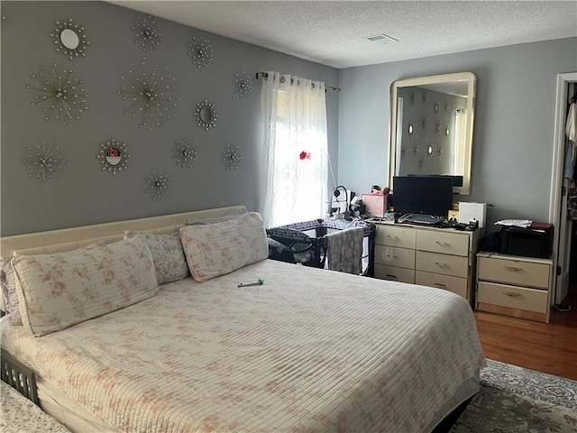 1159 Aurora Ct, Atlanta, GA 30338 - bedroom with wood finished floors and a textured ceiling
