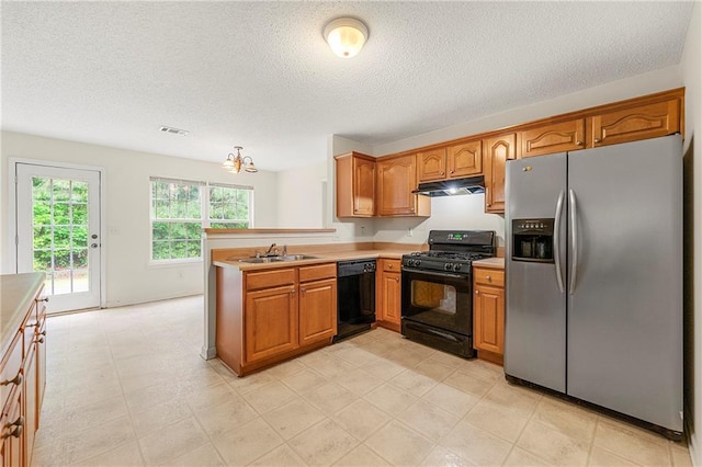 85 Old Gettysburg Way, Dallas, GA 30157 - kitchen with black appliances, under cabinet range hood, brown cabinetry, and a textured ceiling
