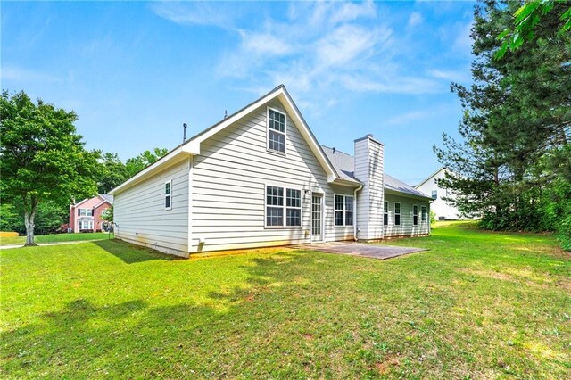 85 Old Gettysburg Way, Dallas, GA 30157 - rear view of property featuring a patio, a lawn, and a chimney