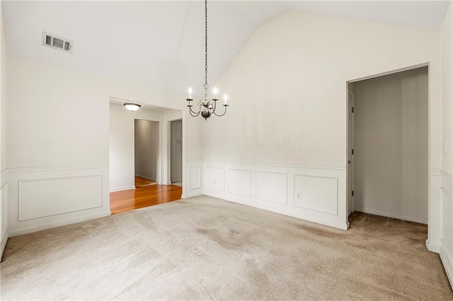 85 Old Gettysburg Way, Dallas, GA 30157 - unfurnished room featuring carpet flooring, a chandelier, a wainscoted wall, a decorative wall, and high vaulted ceiling