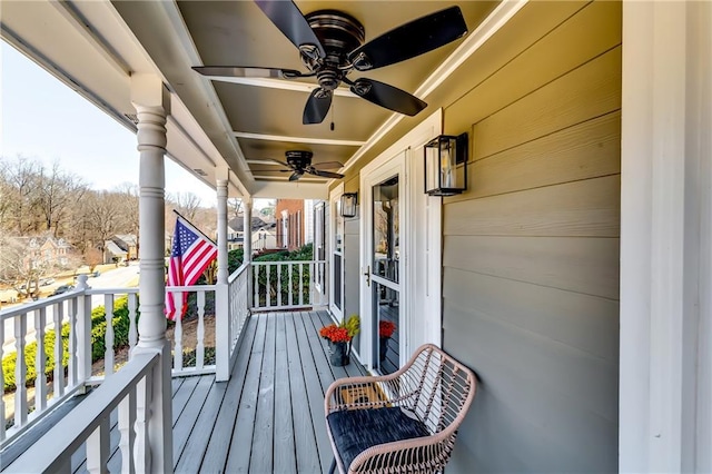 wooden deck with covered porch and ceiling fan