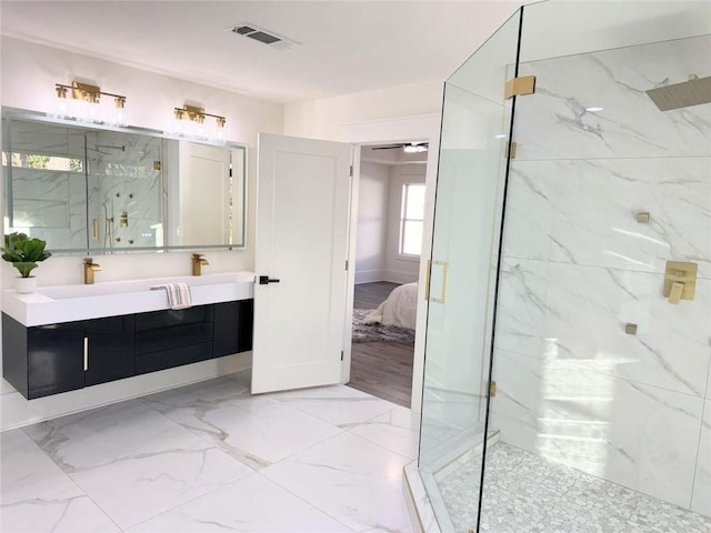 bathroom featuring vanity and a shower with shower door