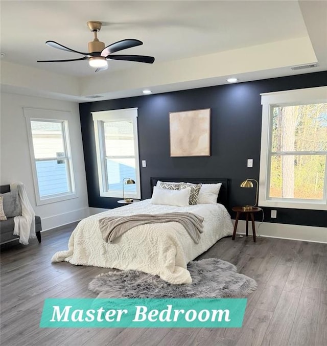 bedroom with ceiling fan and wood-type flooring